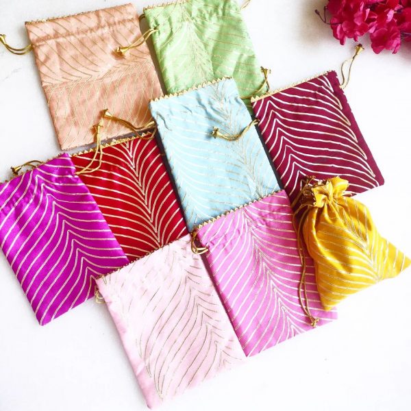 A set of beautifully crafted Lehariya Printed Potlis in an array of colors, showcasing traditional patterns. Perfect for wedding gift hampers, nikah ceremony favors, and bridesmaids gifts