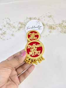 Collection of vibrant "Dulhan ke Mama" brooches featuring green, maroon, and orange designs with intricate golden details for wedding attire accessories