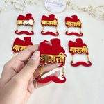 acrylic Baarati brooches with a red and gold design, ideal for groom side brooches and wedding attire accessories at Indian and Nikah weddings