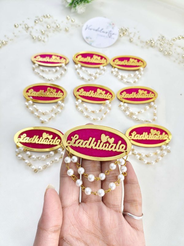 Ladkiwale badge featuring pearl and red bead decorations. Ideal for nikah ceremonies, wedding favors, baarati brooches, and bridal accessories
