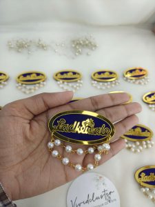 pearl-embellished Ladkewale brooch. The brooch showcases an intricate design with pearls, suitable as a groom side badge or baarati brooch.