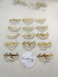 Ladkiwale brooch with intricate designs, featuring pearls and red beads. Ideal for nikah ceremonies, wedding favors, bridal badges