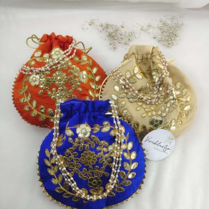 A set of colorful Gota Patti Potli featuring exquisite gold thread work and pearl detailing, suitable for nikah ceremonies and wedding favors