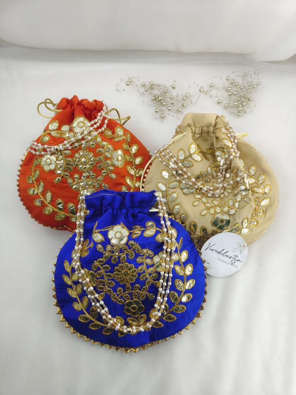 A set of colorful Gota Patti Potli featuring exquisite gold thread work and pearl detailing, suitable for nikah ceremonies and wedding favors