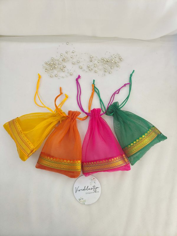 A colorful collection of tissue potli bags, perfect for wedding favors, nikah ceremonies, and special occasions. These bags are ideal for gift hampers, birthdays, and anniversaries