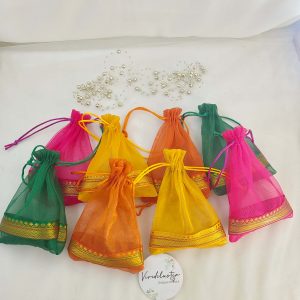 A set of vibrant tissue potli bags, perfect for wedding gifts, nikah ceremonies, and birthday celebrations. These bags are also ideal for anniversary gifts