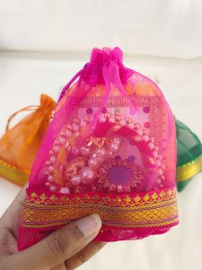 A collection of colorful tissue potli bags, perfect for wedding gifts, nikah ceremonies, and birthday celebrations
