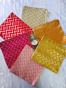 Lehariya printed bags in bright yellow, orange, and pink colors, adorned with zigzag patterns. These stylish bags, perfect for weddings and nikah ceremonies, can serve as wedding favors, gift hampers