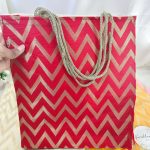 Red Lehariya printed bag with zigzag patterns. These bags are perfect for weddings and bridesmaids return favor