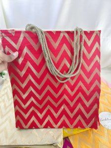 Red Lehariya printed bag with zigzag patterns. These bags are perfect for weddings and bridesmaids return favor
