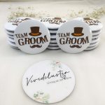 Multiple white round badges with "TEAM GROOM" printed in bold brown letters, accompanied by a stylish brown top hat and mustache graphic Ideal for wedding favors, especially for the groom's party.