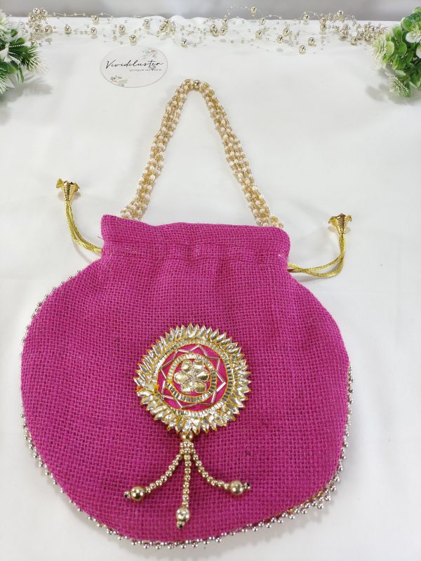 A vibrant pink Gota Jute Potli bag featuring intricate golden embellishments and a decorative handle, ideal for wedding favors and gift hampers, perfect for nikah ceremonies and bridesmaids