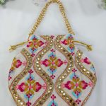 a beautifully crafted potli bag with intricate embroidery featuring colorful flowers and shimmering gold accents erfect for use as a wedding favor, nikah ceremony gift, or bridesmaid's present.