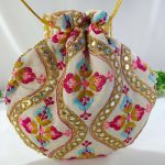 potli bag with detailed embroidery in vibrant colors and golden decorations. The bag is tied with a golden drawstring and is perfect for weddings, nikah ceremonies,