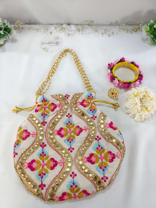 embroidered potli bag, showcasing vibrant floral patterns in pink, yellow, and blue, accented with golden beads and sequins. The bag is cinched at the top with a golden drawstring, making it ideal for weddings, nikah ceremonies, and as a wedding favor, gift hamper