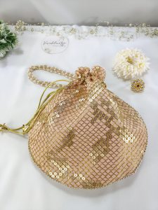 SippI Gota Potli, embellished with gold sequins forming a traditional motif on soft pink fabric. This potli bag is perfect for weddings, nikah ceremonies, and as a luxurious wedding favor or bridesmaid gift