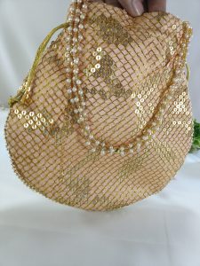 Sippy Gota Potli bag with shimmering gold sequins arranged in a traditional pattern on soft pink fabric. This exquisite potli is designed for weddings, nikah ceremonies, and bridal gift hampers, making it a luxurious choice for bridesmaids’ favors or wedding giveaways