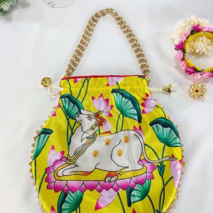 potli bag with an artistic depiction of a cow resting on lotus flowers, adorned with leafy accents, perfect for a nikah ceremony gift