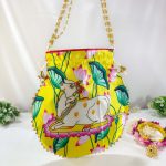 potli bag design featuring a calm white cow amidst vibrant lotus flowers and leaves, ideal for wedding giveaways and gift hampers