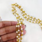 Colorful potli bag adorned with a serene cow image, framed by bright floral and leaf patterns, perfect for nikah ceremony favors