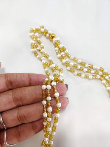 Colorful potli bag adorned with a serene cow image, framed by bright floral and leaf patterns, perfect for nikah ceremony favors