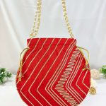 "Handcrafted red Gota Potli with detailed gold patterns and pearl handles, perfect for weddings, nikah ceremonies