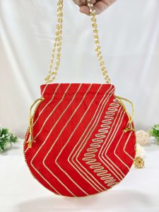 "Handcrafted red Gota Potli with detailed gold patterns and pearl handles, perfect for weddings, nikah ceremonies