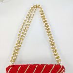 Red bridal potli bag with exquisite gold gota work and pearl detailing, ideal for wedding favor giveaways and nikah ceremonies