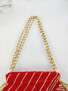 Red bridal potli bag with exquisite gold gota work and pearl detailing, ideal for wedding favor giveaways and nikah ceremonies