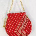 Traditional red potli bag with gold gota and pearl accents, ideal for wedding favors, bridal gifts, and nikah ceremony giveaways.