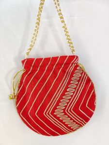 Traditional red potli bag with gold gota and pearl accents, ideal for wedding favors, bridal gifts, and nikah ceremony giveaways.