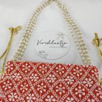 Embroidered Wedding Potli in vibrant red, featuring detailed white designs, perfect for a bride’s wedding accessories, nikah ceremony gifts, or wedding favors for bridesmaids.