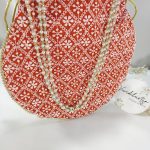 Red Embroidery Potli with delicate white designs, ideal for use as a wedding favor, bridesmaid gift, or accessory for a nikah ceremony
