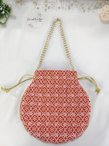 Beautifully designed Embroidery Wedding Potli with white patterns on a vibrant red fabric, perfect for wedding gifts, bridesmaid favors, or as a special accessory for the bride