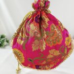 pink potli bag, intricately designed with golden floral embroidery, adorned with a gold drawstring, perfect for wedding favors, nikah ceremonies, and bridesmaid gifts