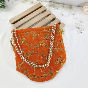 Embroidery Wedding Potlis for Bridal Shower and Wedding Favors: A beautifully embroidered potli bag in vibrant orange, adorned with intricate golden floral designs. This handmade potli is perfect for wedding favors, nikah ceremonies, and bridal showers.