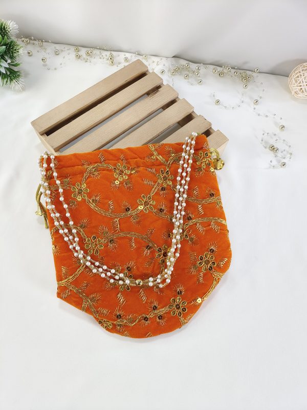 Embroidery Wedding Potlis for Bridal Shower and Wedding Favors: A beautifully embroidered potli bag in vibrant orange, adorned with intricate golden floral designs. This handmade potli is perfect for wedding favors, nikah ceremonies, and bridal showers.