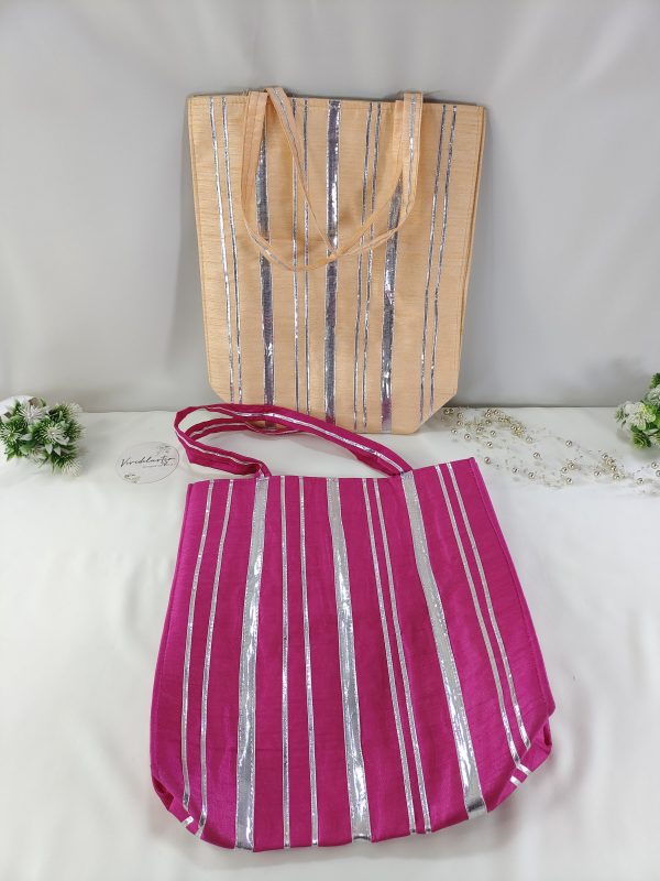 designer Nikah Potli Bags . The bags feature vertical silver stripes on a background of deep pink and peach, making them a stylish choice for wedding favors, bridal shower gifts, or bridesmaid accessories