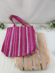 The bags, in pink and peach with silver stripes, are perfect for giving as wedding favors, bridal shower gifts, or bridesmaid accessories. Their classic design is perfect for adding a traditional touch to any wedding or nikah ceremony