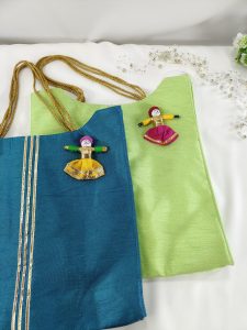 potli bags in blue and green, enhanced with handmade doll decorations. Ideal for wedding accessories, bridal showers, and birthday gifts.