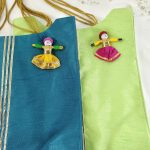 potli bags crafted in blue and green fabric, detailed with handcrafted dolls. Ideal for wedding favors, bridesmaid gifts, and giveaway favors at nikah ceremonies