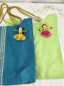 potli bags crafted in blue and green fabric, detailed with handcrafted dolls. Ideal for wedding favors, bridesmaid gifts, and giveaway favors at nikah ceremonies