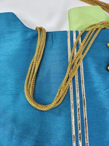Blue and green potli bags with doll embellishments, designed for wedding favors, nikah ceremonies, and bridal shower presents