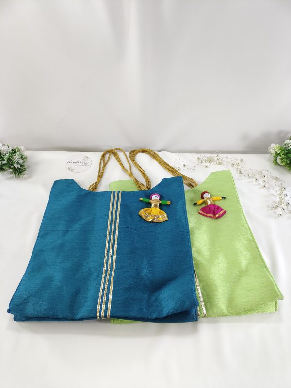 potli bags crafted in blue and green fabric, detailed with handcrafted dolls. Ideal for wedding favors, bridesmaid gifts, and giveaway favors at nikah ceremonies