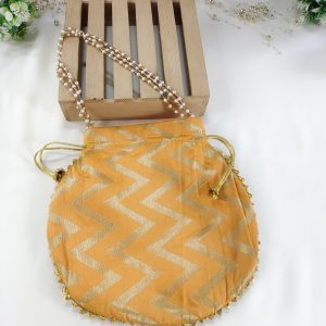 Lehariya printed bags in bright orange adorned with zigzag patterns. These stylish bags, perfect for weddings and nikah ceremonies, can serve as wedding favors, gift hampers