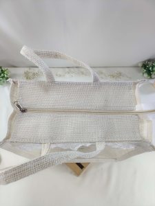 A natural jute potli bag with intricate lace detailing, designed to complement any wedding theme. Perfect for nikah ceremonies, bridal showers, and as a thoughtful bridesmaid gift