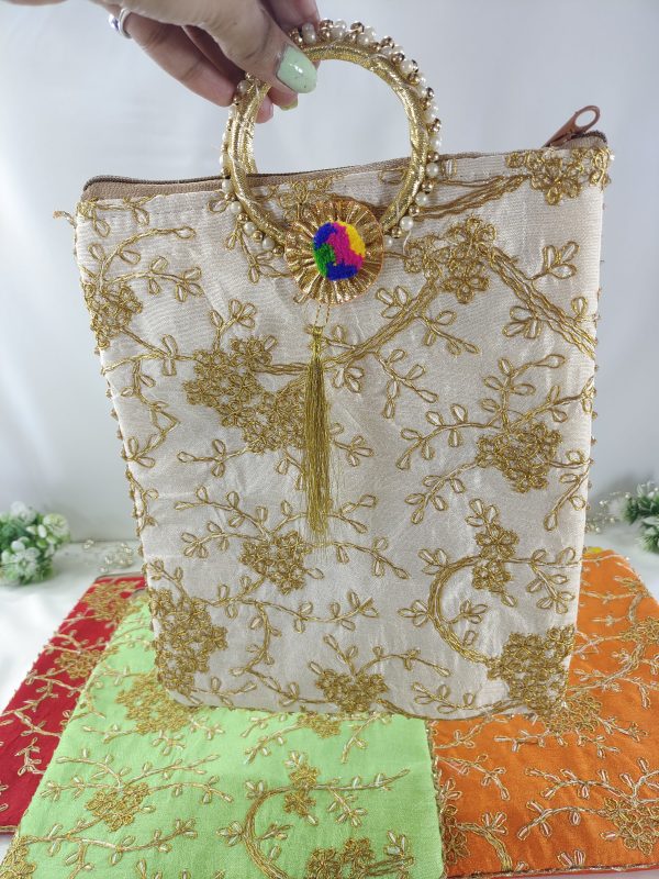 white embroidery potli features a range of vibrant colors that are perfect for any wedding event. The bags are decorated with golden floral embroidery and a matching golden handle with a tassel. Ideal for use as bridal shower gifts, nikah ceremony accessories0bag