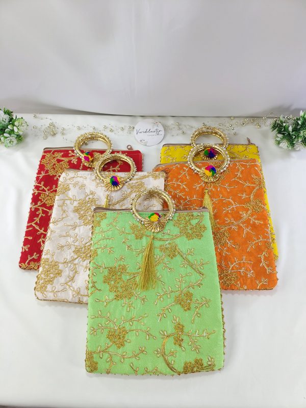 embroidered potli bags. Available in a variety of colors, each bag is adorned with golden floral patterns and features a golden handle with a tassel. These bags make ideal wedding favors, bridal shower gifts