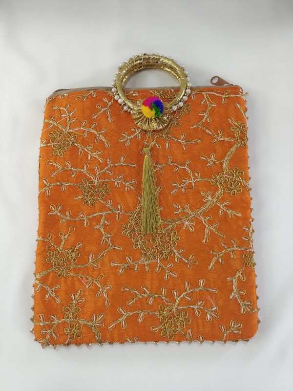 orange embroidery potli features a range of vibrant colors that are perfect for any wedding event. The bags are decorated with golden floral embroidery and a matching golden handle with a tassel. Ideal for use as bridal shower gifts, nikah ceremony accessories0bag