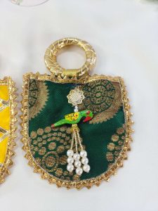 green potli pouches with gold lacework and parrot accents, ideal for weddings, bridesmaid gifts,